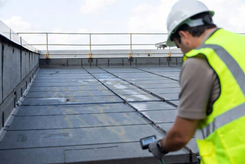 Перевірка протікання плоскої покрівлі після нанесення гідроізоляції, професійний контроль якості.